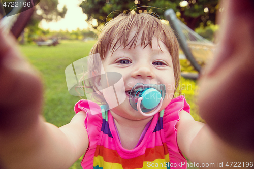 Image of little girl spending time at backyard