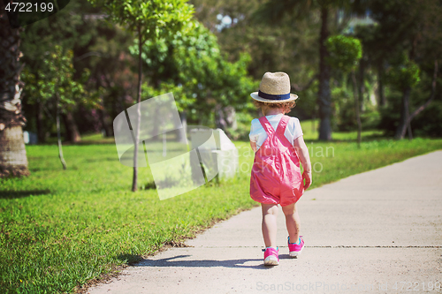 Image of little girl runing in the summer Park