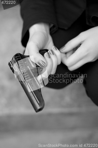 Image of gun in female hands