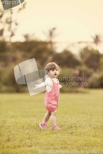 Image of little girl spending time at backyard