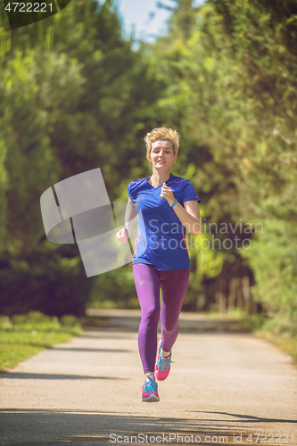 Image of young female runner training for marathon