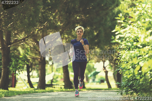 Image of young female runner training for marathon