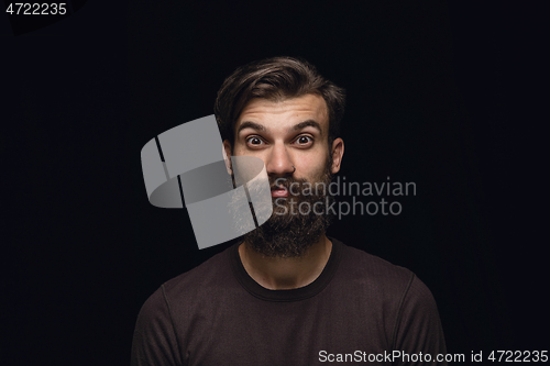 Image of Close up portrait of young man isolated on black studio background