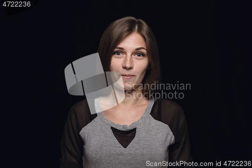 Image of Close up portrait of young woman isolated on black studio background