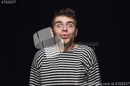 Image of Close up portrait of young man isolated on black studio background