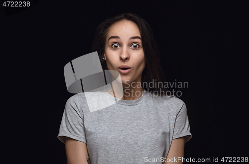 Image of Close up portrait of young woman isolated on black studio background