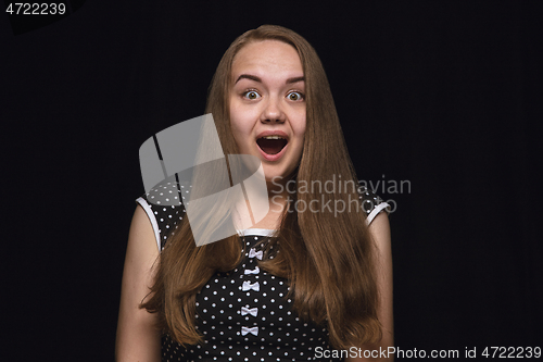 Image of Close up portrait of young woman isolated on black studio background