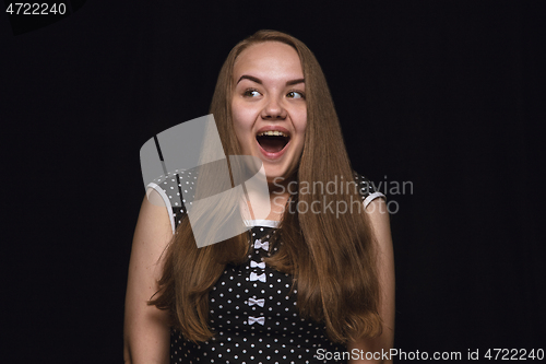 Image of Close up portrait of young woman isolated on black studio background