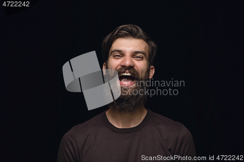 Image of Close up portrait of young man isolated on black studio background