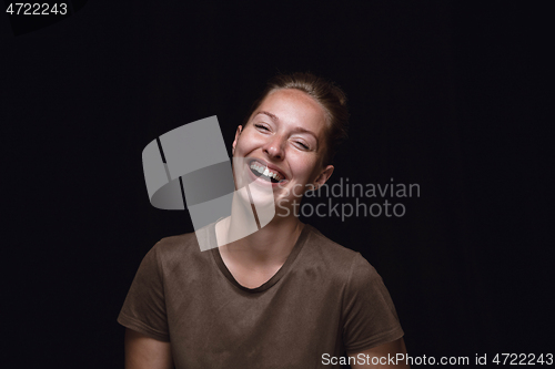 Image of Close up portrait of young woman isolated on black studio background