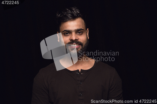 Image of Close up portrait of young man isolated on black studio background