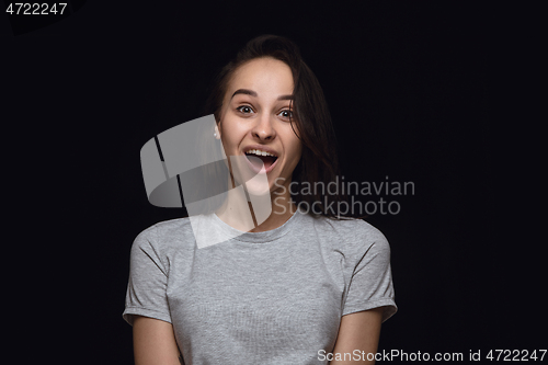 Image of Close up portrait of young woman isolated on black studio background