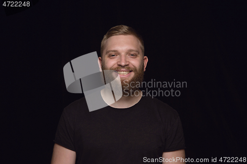 Image of Close up portrait of young man isolated on black studio background