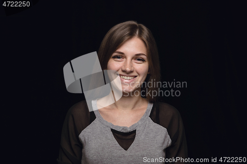 Image of Close up portrait of young woman isolated on black studio background