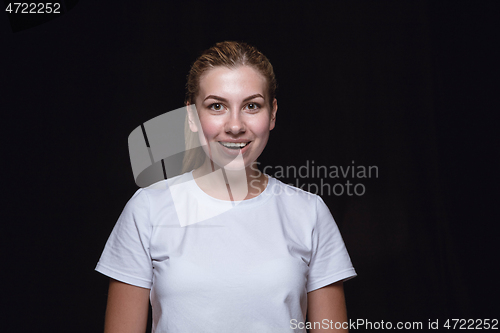 Image of Close up portrait of young woman isolated on black studio background