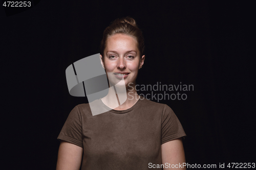 Image of Close up portrait of young woman isolated on black studio background