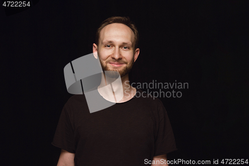 Image of Close up portrait of young man isolated on black studio background