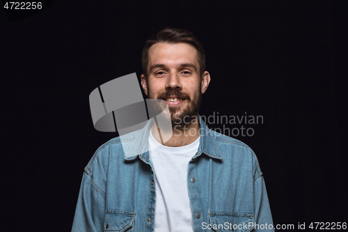 Image of Close up portrait of young man isolated on black studio background