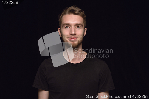 Image of Close up portrait of young man isolated on black studio background