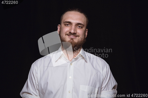 Image of Close up portrait of young man isolated on black studio background