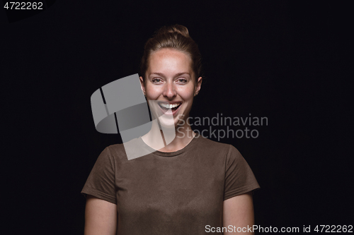 Image of Close up portrait of young woman isolated on black studio background