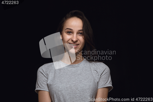 Image of Close up portrait of young woman isolated on black studio background