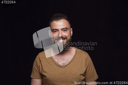 Image of Close up portrait of young man isolated on black studio background