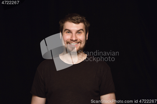 Image of Close up portrait of young man isolated on black studio background