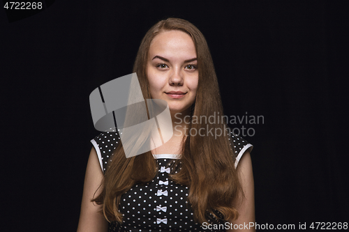 Image of Close up portrait of young woman isolated on black studio background