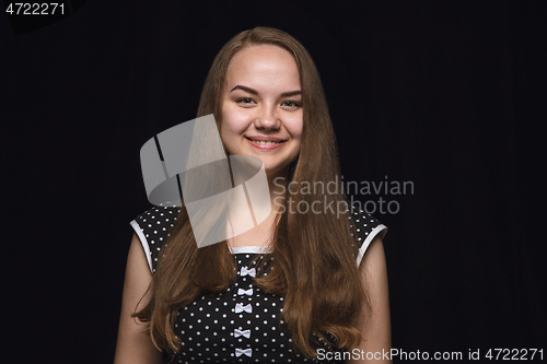 Image of Close up portrait of young woman isolated on black studio background