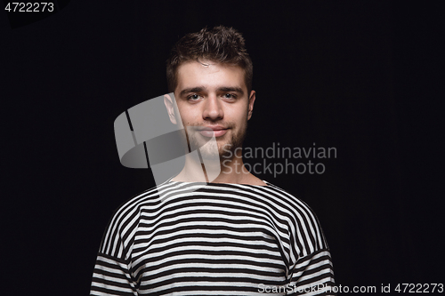 Image of Close up portrait of young man isolated on black studio background