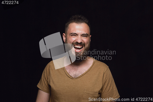 Image of Close up portrait of young man isolated on black studio background