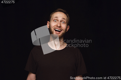 Image of Close up portrait of young man isolated on black studio background