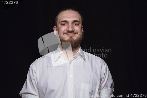 Image of Close up portrait of young man isolated on black studio background