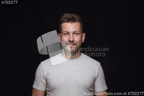 Image of Close up portrait of young man isolated on black studio background