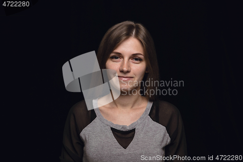 Image of Close up portrait of young woman isolated on black studio background