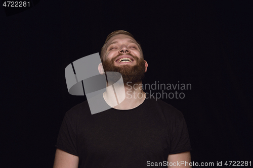 Image of Close up portrait of young man isolated on black studio background