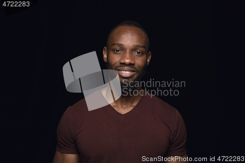 Image of Close up portrait of young man isolated on black studio background