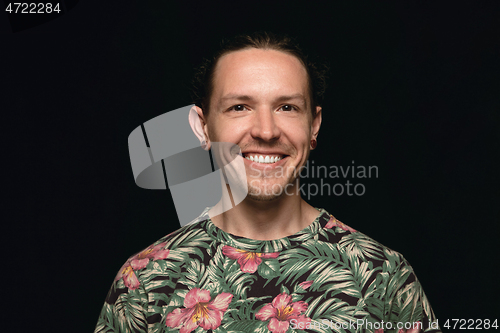 Image of Close up portrait of young man isolated on black studio background