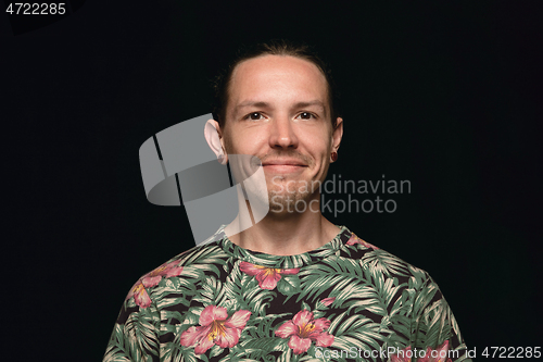 Image of Close up portrait of young man isolated on black studio background