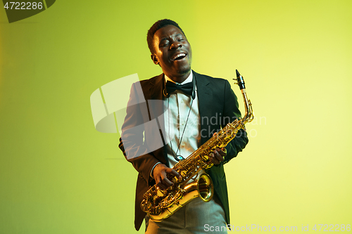 Image of Young african-american jazz musician playing the saxophone