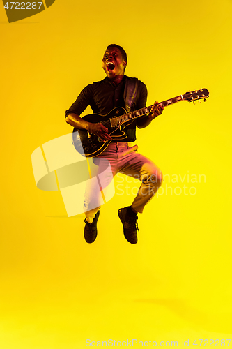 Image of Young african-american jazz musician playing the guitar