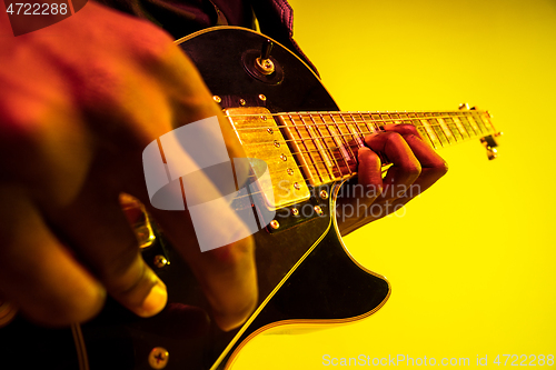 Image of Young african-american jazz musician playing the guitar