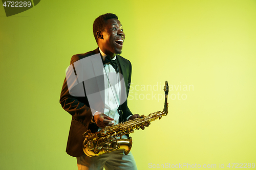 Image of Young african-american jazz musician playing the saxophone