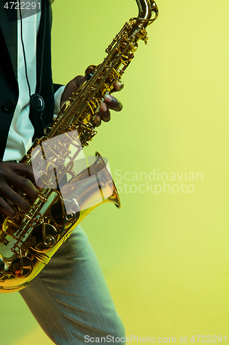 Image of Young african-american jazz musician playing the saxophone