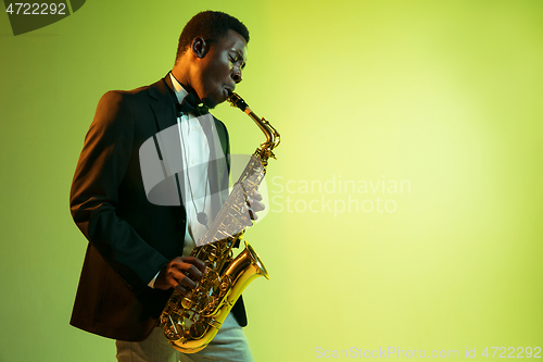 Image of Young african-american jazz musician playing the saxophone