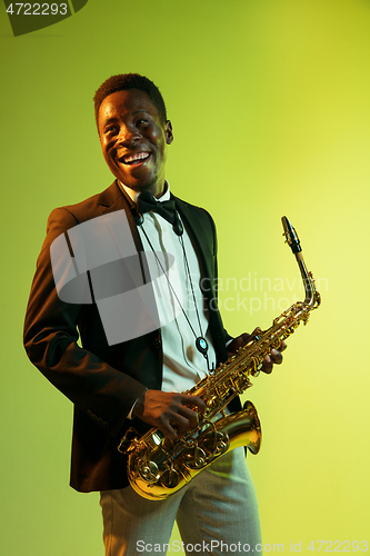 Image of Young african-american jazz musician playing the saxophone