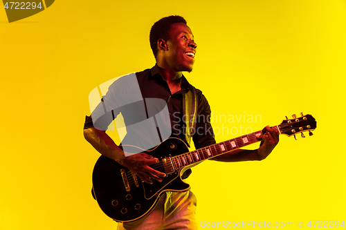 Image of Young african-american jazz musician playing the guitar