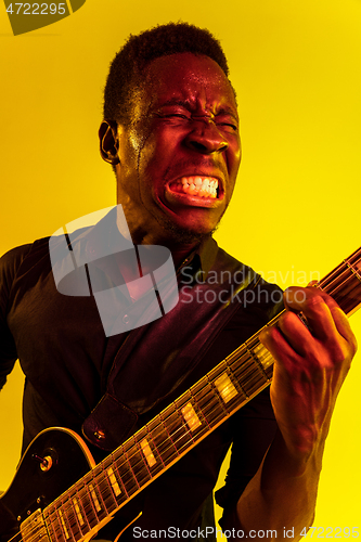 Image of Young african-american jazz musician playing the guitar