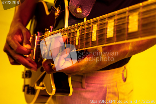 Image of Young african-american jazz musician playing the guitar